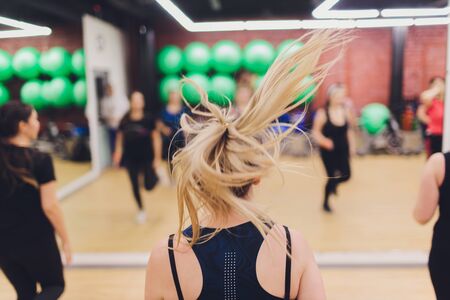 fitness, sport, training, gym and lifestyle concept - group of women working out in gym