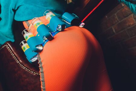 A yellow shot of tequila young woman in orangeの写真素材