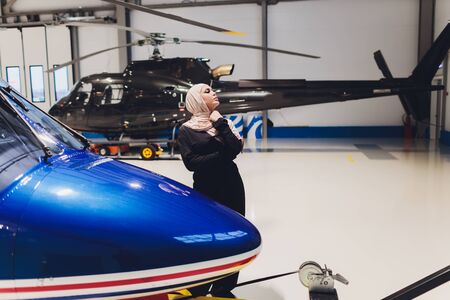 Elegant business muslim arab woman near the helicopter. Business, success and luxury concept....