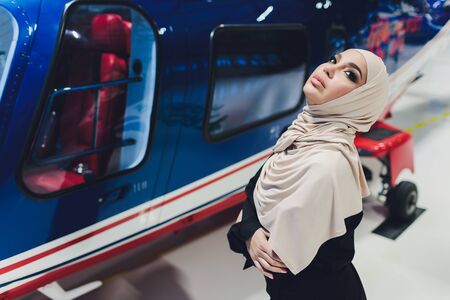 Elegant business muslim arab woman near the helicopter. Business, success and luxury concept....