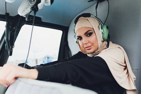 Elegant business muslim arab woman near the helicopter. Business, success and luxury concept.の写真素材