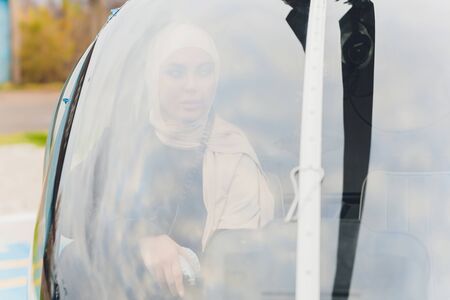 Elegant business muslim arab woman near the helicopter. Business, success and luxury concept.