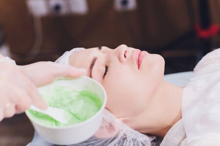 Upper view of a womansUpper view of a woman's face covered by alginate mask while leaning on a spa bedの写真素材