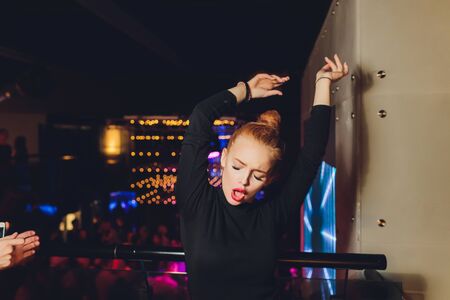 Attractive woman dressed in fashion apparel in neon night lights.の写真素材