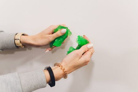 Slime, green pate elastic and vicous on child's handの写真素材