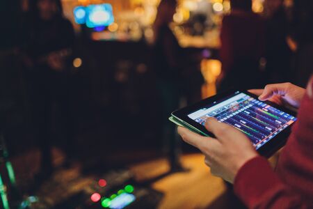 Professional sound engineer console at concert. Concert sound engineer hands at workの写真素材