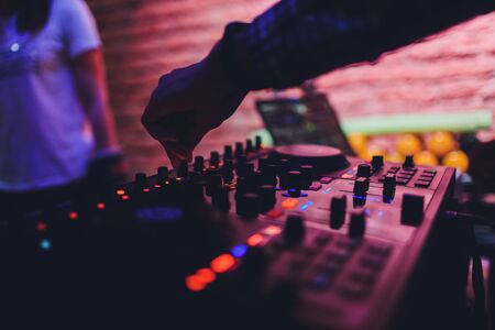 DJ remote, turntables, and hands . Night life at the club, party.の写真素材