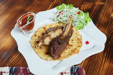 Barbecue spare ribs on an rustic wooden tableの写真素材