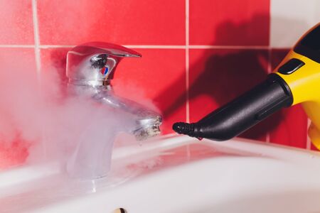 Water tap in detail with limescale close up soiled bathroom Calcified faucet cleaning with steam cleanerの写真素材
