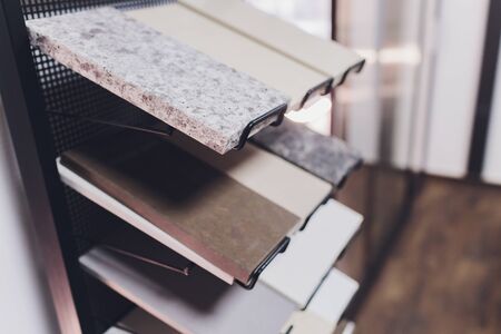 home furnishing store demonstrating variants of stone for kitchen countertopの写真素材