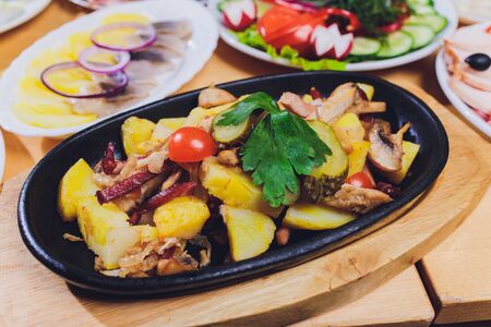 original fajita sizzling smoking hot served on iron plate and fresh vegetables on backgroundの写真素材