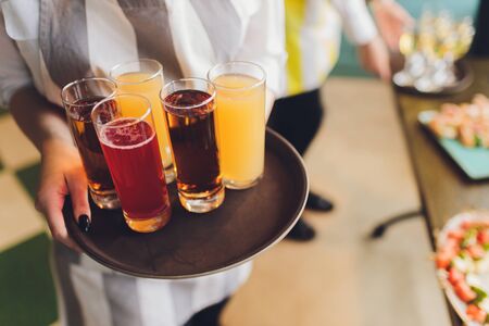Glasses of fresh juice on an old wooden table.
