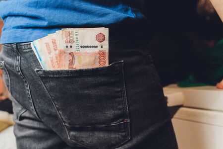 Rubles in hands. Stack of money. Black background.の写真素材
