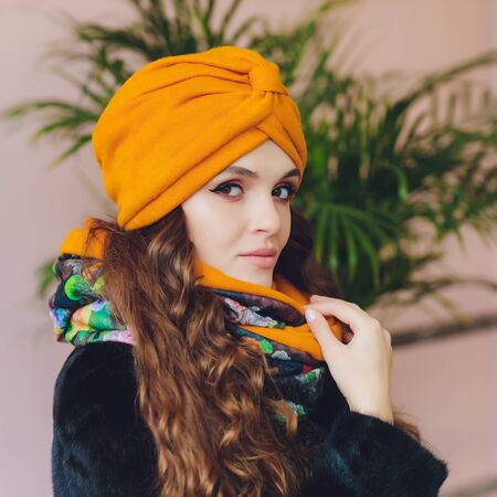 Photo of self assured Arabian lady in hijab, shows you right way, points at blank space with both fore fingers, invites going there, promots copy space. Check it out with me.の写真素材