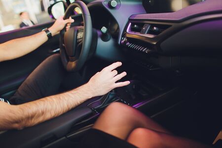 Businessman driving luxury modern car in the city. Close up man's hand on the gearbox