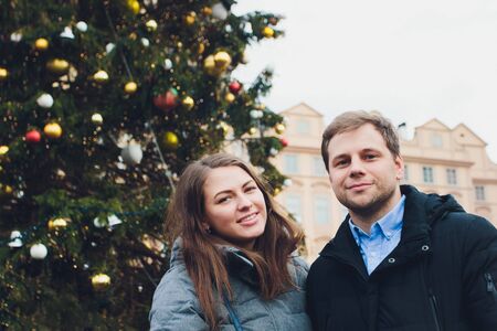 Happy couple near a Christmas tree. Christmas Eve.の写真素材