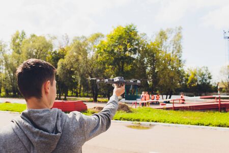 Drone remote control in hand man.Man operating of flying drone.