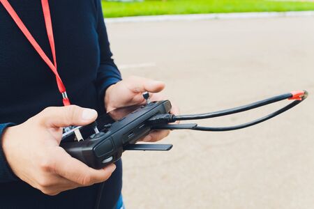 Drone remote control in hand man.Man operating of flying drone.