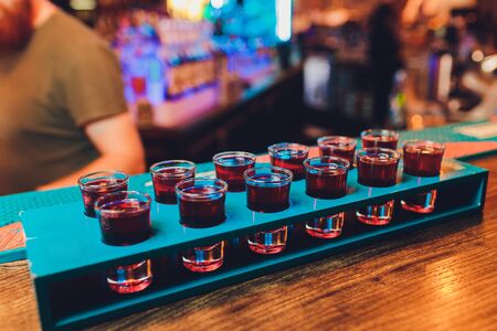 Barman make alcoholic shots with rum and liquorの写真素材