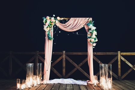 Wedding arch for wedding ceremony. Beautiful wedding decor in rustic style.の写真素材