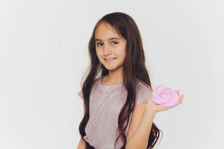 Young girl playing with slime. Isolated on white background.