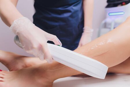 Laser epilation of leg in a modern beauty shop.の写真素材