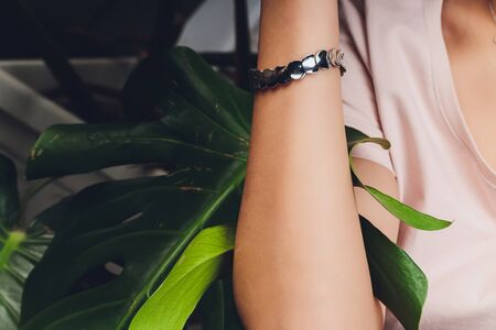 elegant young woman with jewelry at restaurant.の写真素材