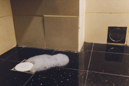 Abstract bubbles white foam of washing powder on grey floor.bubbles soap cleaning floorの写真素材