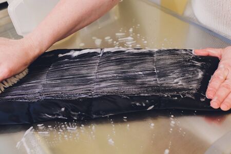 Laundry worker in the process of cleaning fur brush.の写真素材