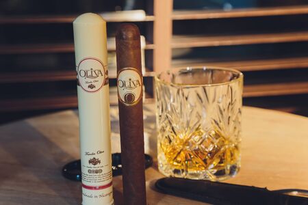 Ufa, Russia, 15 November, 2018: Whiskey drinks with cigars on wooden tableのeditorial素材