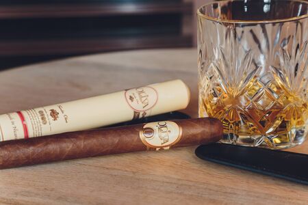 Ufa, Russia, 15 November, 2018: Whiskey drinks with cigars on wooden tableのeditorial素材