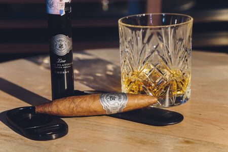 Ufa, Russia, 15 November, 2018: Whiskey drinks with cigars on wooden tableのeditorial素材