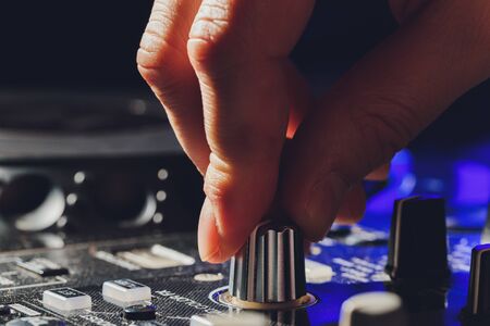 music, technology, people and equipment concept - man using mixing console in sound recording studio.の写真素材