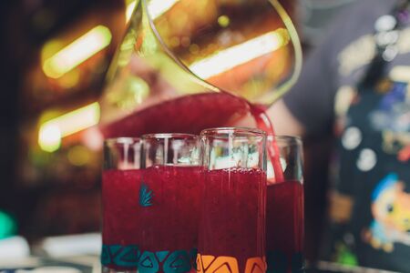 Glasses of fresh juice on an old wooden tableの写真素材