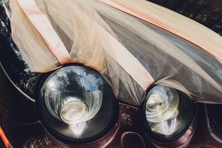 Close-up of Vintage Wedding Car Decorated with Flowersの写真素材