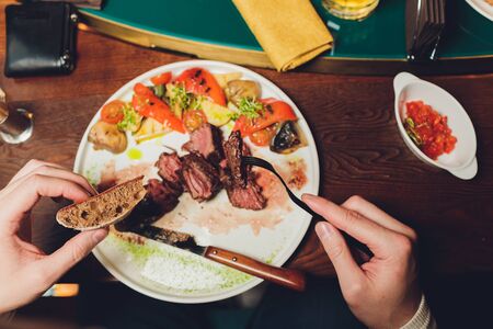 Grilled salmon fish with fresh vegetables on plateの写真素材