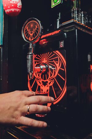 Ufa, Russia, HARATS PUB, 15 November, 2018: Jagermeister alcohol drinks in bar. bartender pours a glass.のeditorial素材
