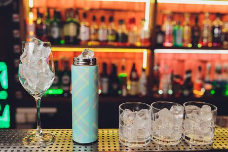 A bartender makes a cocktail over the marble bar counterの写真素材