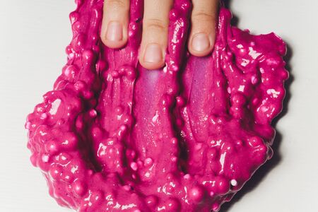 Kid Playing Hand Made Toy Called Slime Alien drool Shell musselの写真素材