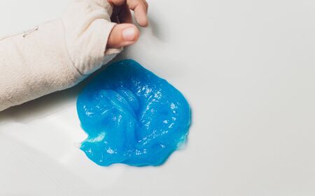 Kid Playing Hand Made Toy Called Slime Alien drool Shell mussel.の写真素材