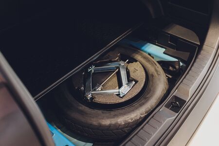 spare tire in the trunk of a modern carの写真素材