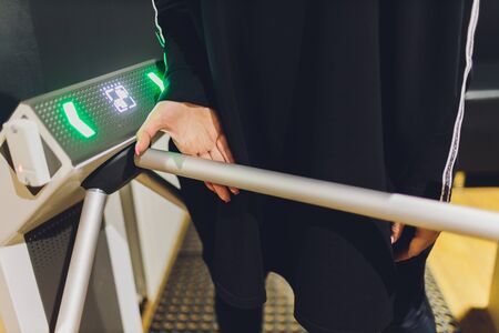 Portrait of arab muslim woman walking through platform barrier.