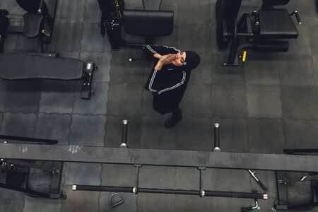 Muslim asian woman in hijab exercizing in a gym.