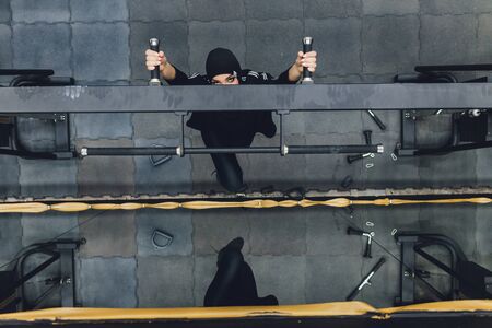 Muslim asian woman in hijab exercizing in a gym.の写真素材