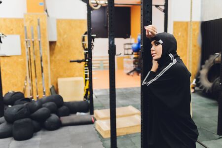 Muslim asian woman in hijab exercizing in a gym.の写真素材