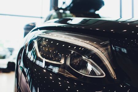 close up headlights front side view , black color car in room.の写真素材