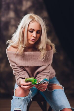 Womans hands holding brown leather wallet with new banknotes nominal 200 rubles. Russian cash money.の写真素材
