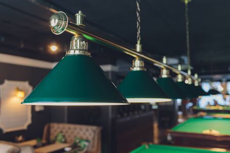 lamp over billiards green table balls and cuesの写真素材