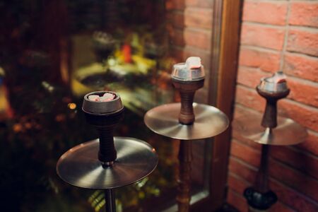 Clay shisha bowl with craft flawoured tobacco and red hot coconut coil with hookah smoke black...