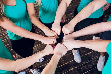 Portrait of happy fit young female friends stacking hands
